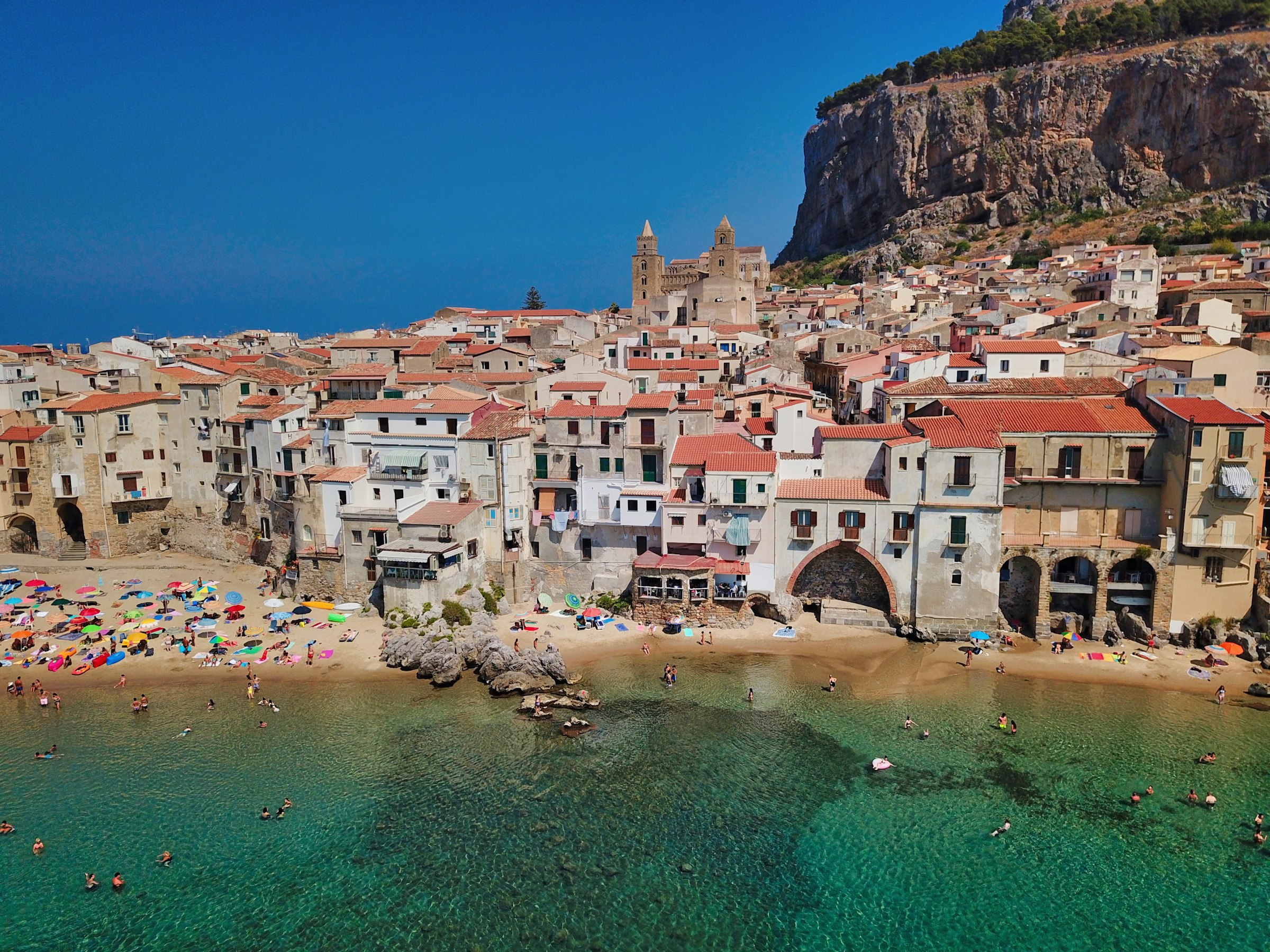 Cefalù, Sicily: old town houses and beach below the La Rocca headland