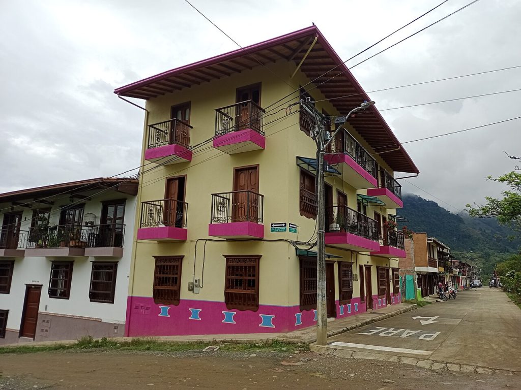 Houses with bright pink and yellow wooden balconies