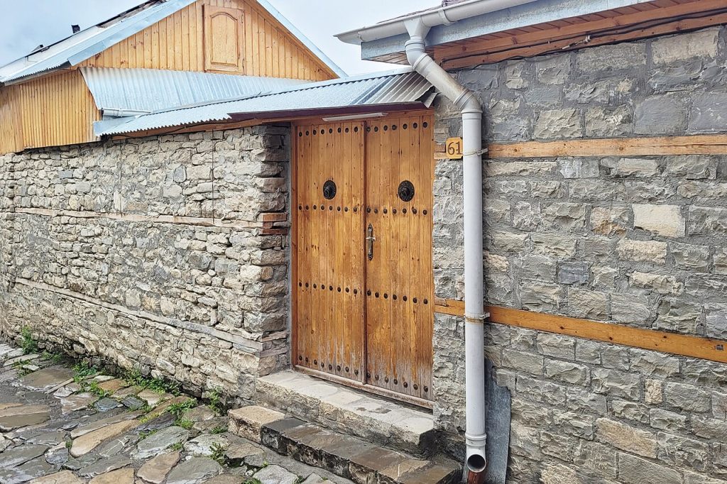 A carved and decorated doorway in a stone wall in Lahij