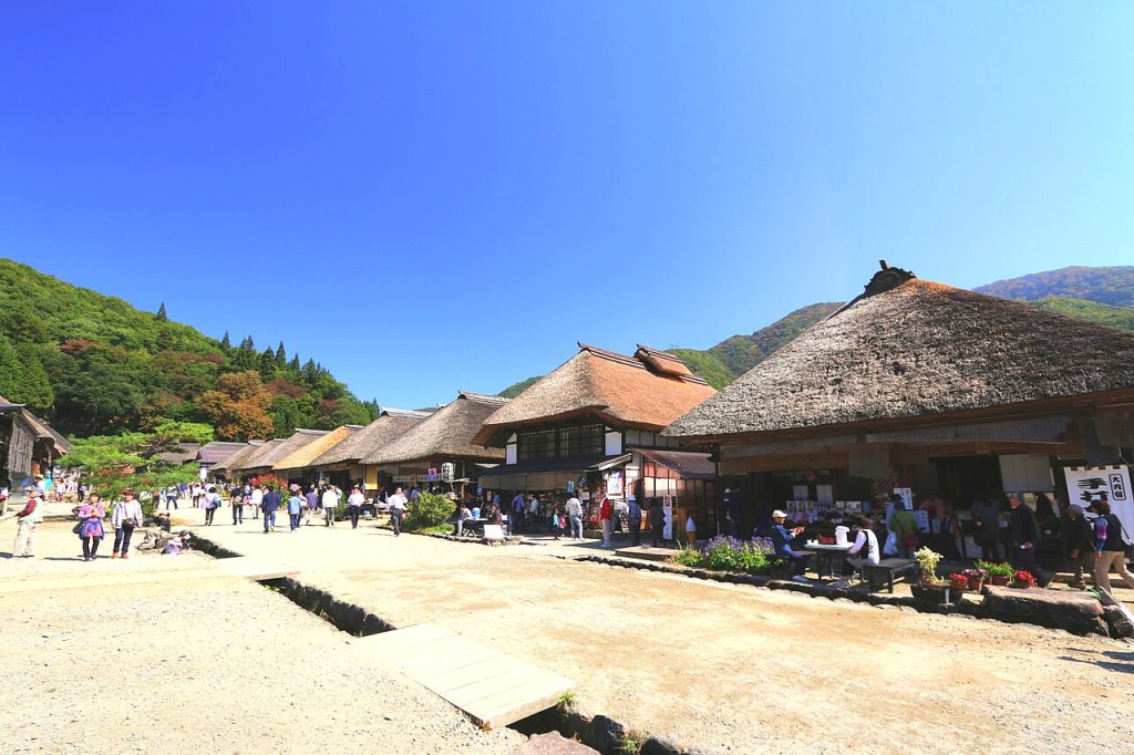 The main street of an Edo-period post town lined with thatched houses