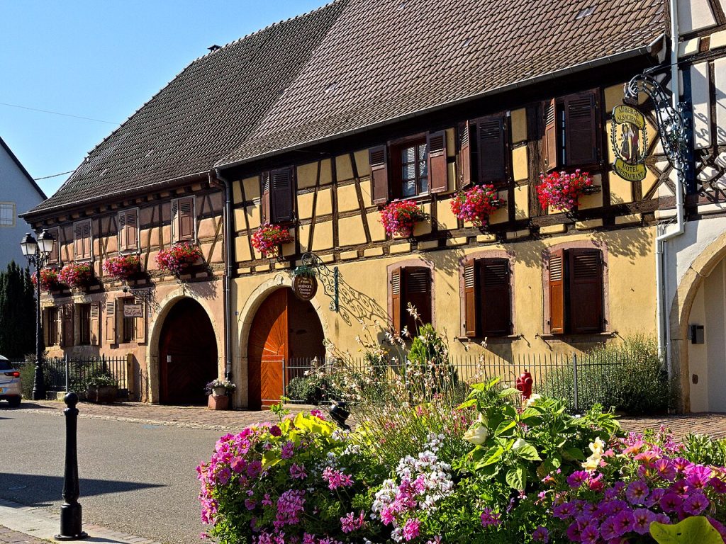 Colorful half-timbered houses with flower boxes along a curving lane
