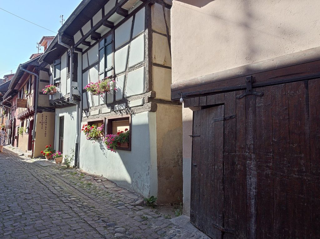 A narrow lane lined with old timber-framed houses