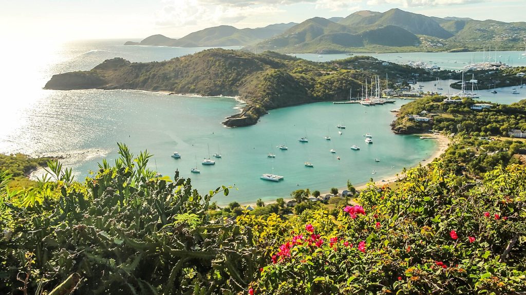 English Harbour Antigua seen from Shirley Heights with green hills and anchored yachts