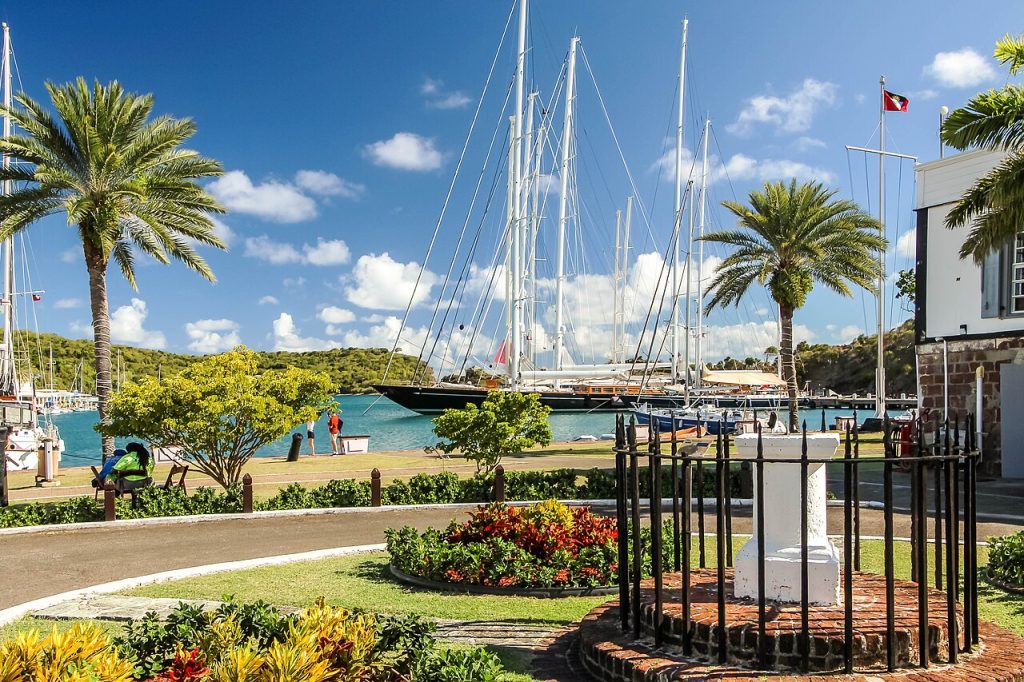 Sailing yachts moored beside palm trees in English Harbour