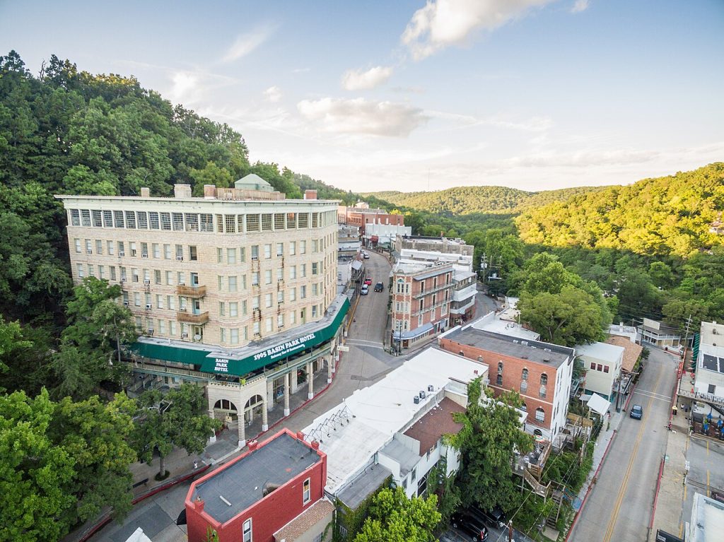 Aerial view of Eureka Springs Arkansas and its Victorian downtown among wooded hills