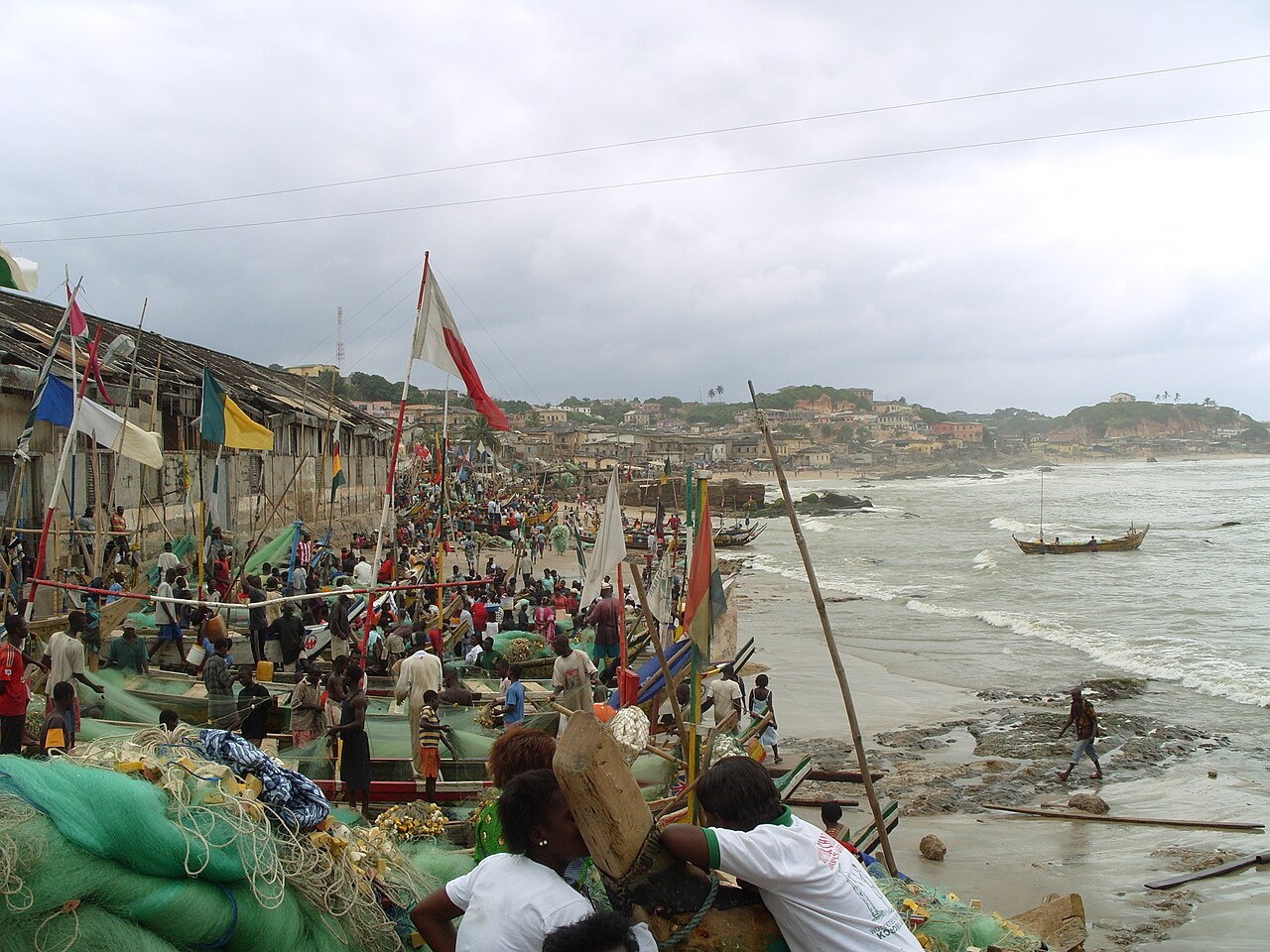 Fishermen working with nets on the shore