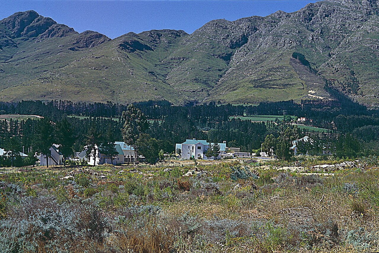 Valley farms with mountains rising beyond