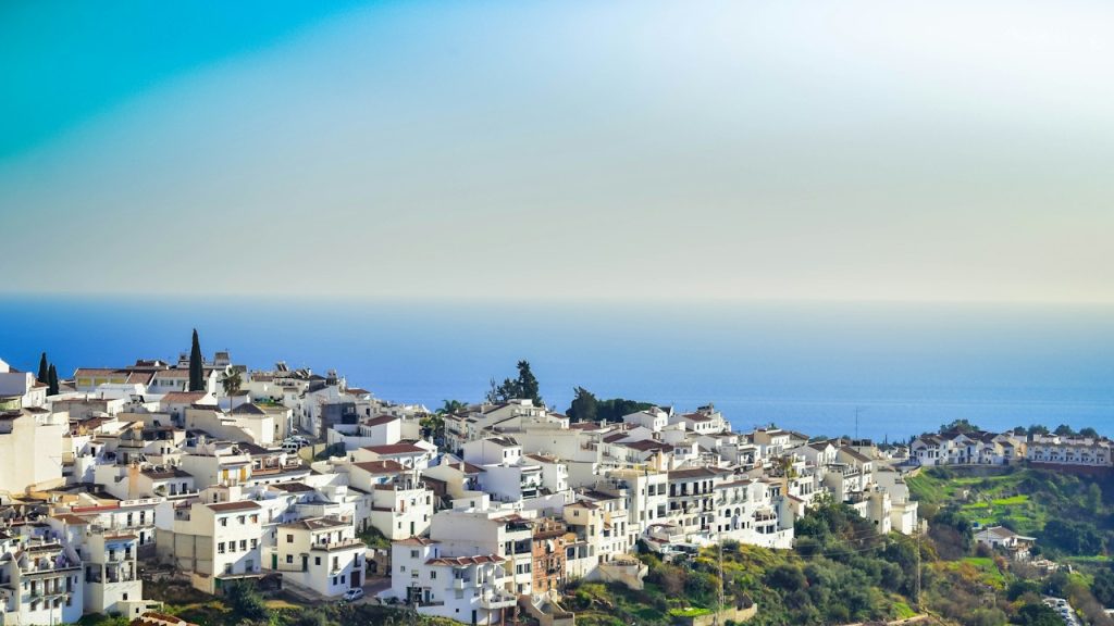 White village on a hillside with the Mediterranean Sea beyond