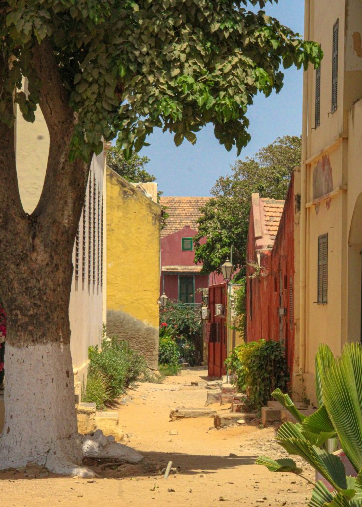 Yellow and red colonial houses along a quiet car-free street