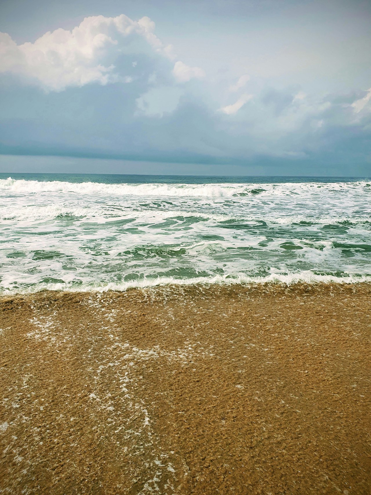Sandy beach with waves rolling in