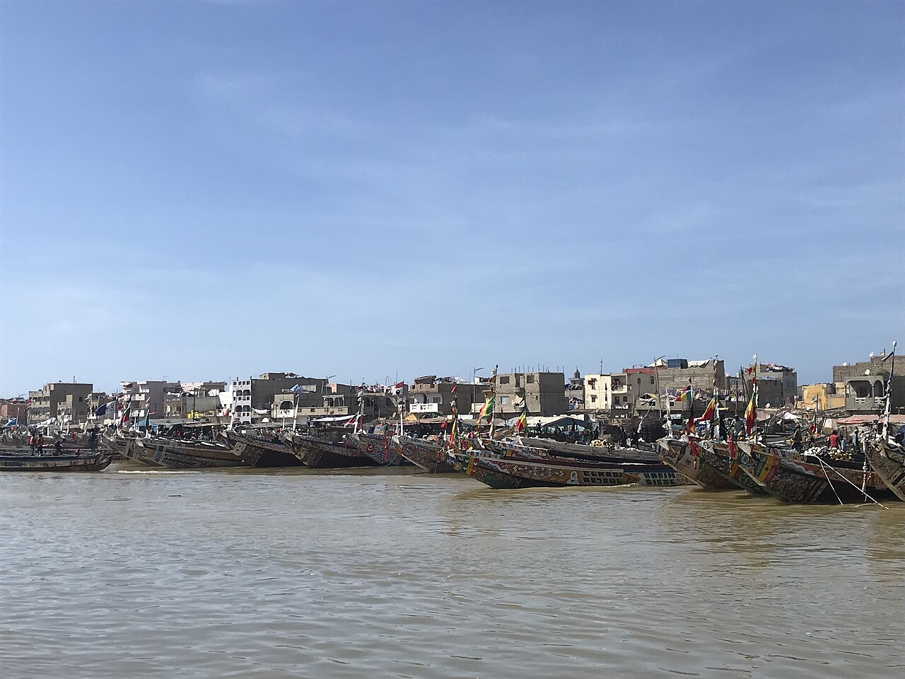 Colorful painted fishing pirogues pulled up on the beach at Guet Ndar
