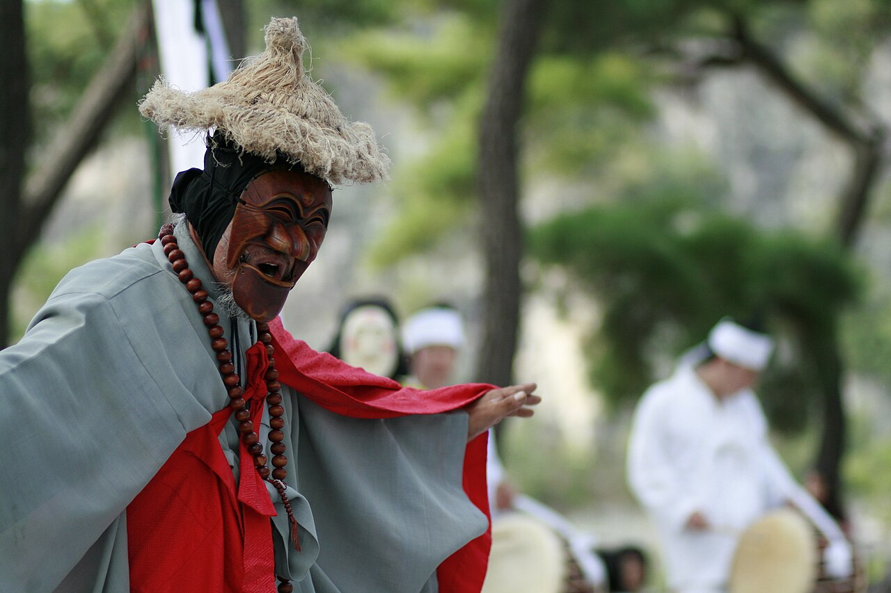 Performers in wooden masks during a mask dance in Hahoe Folk Village