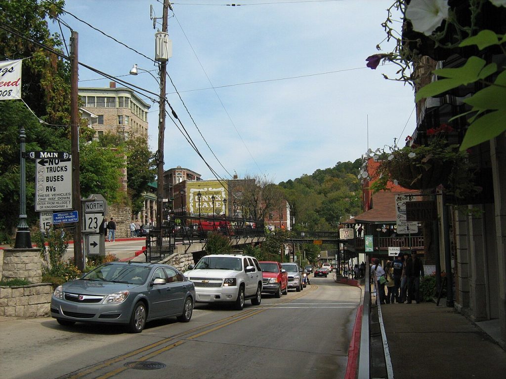 Shops and old storefronts on a hilly main street