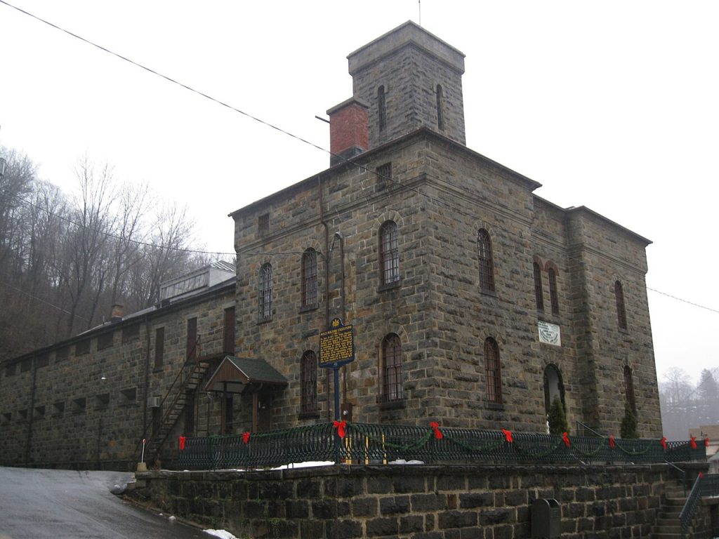 A historic stone building on a steep street