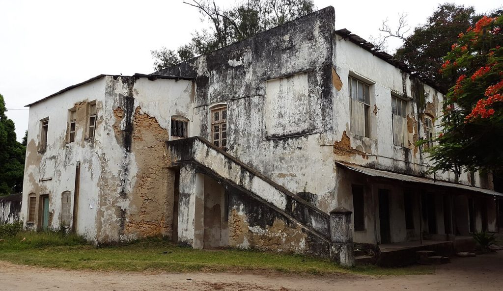 A crumbling historic building with arched windows