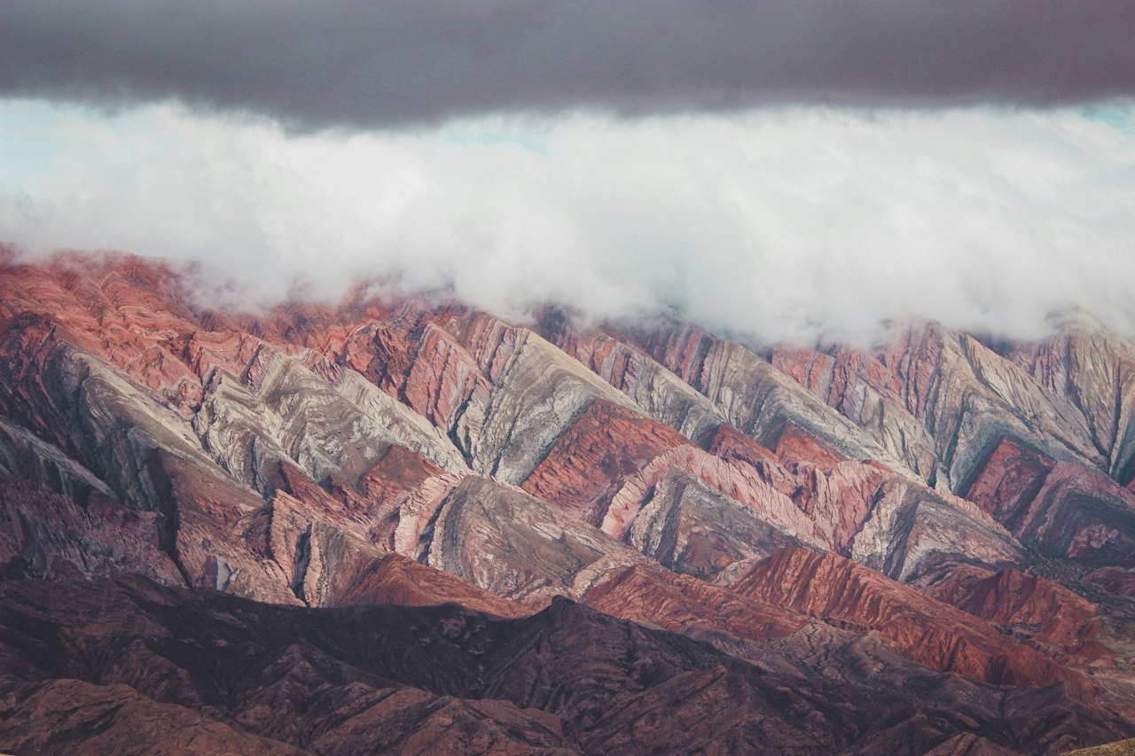 Brown and gray mountains under white clouds