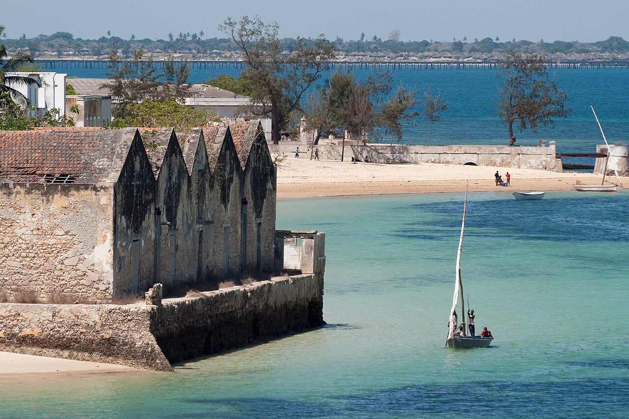 Old warehouses and a dhow in turquoise water on the Island of Mozambique