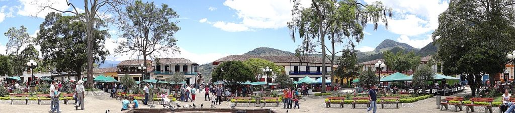 The main plaza with trees and green mountains behind