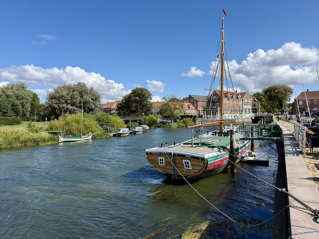 A historic sailing ship moored on the river by the old harbor