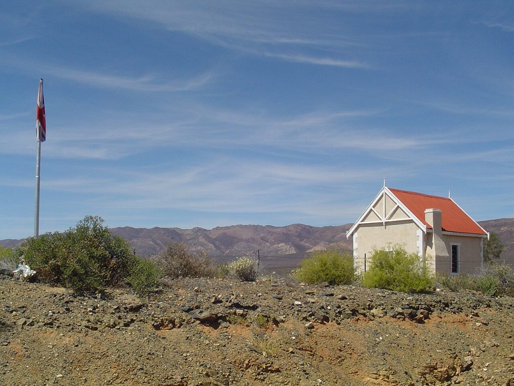 A small historic building against the mountains of the Karoo