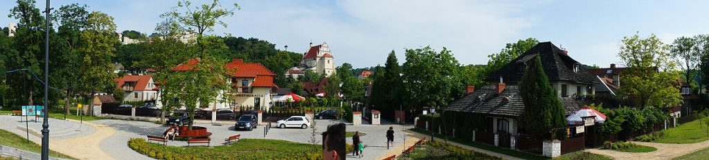 Red roofs and church towers among green hills