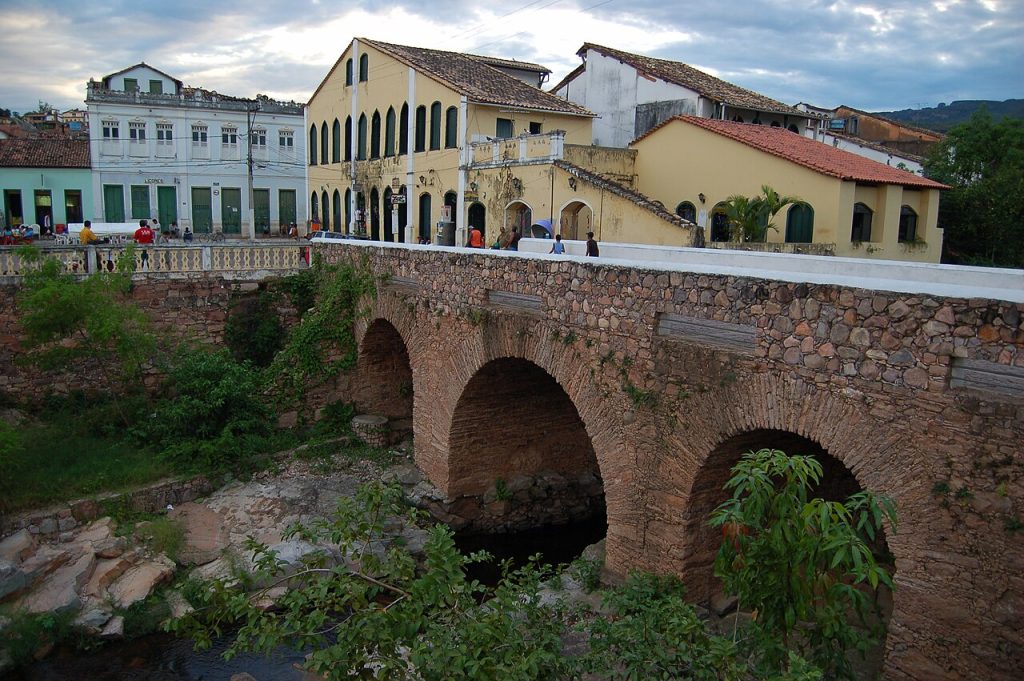 An old stone bridge with arches over a river