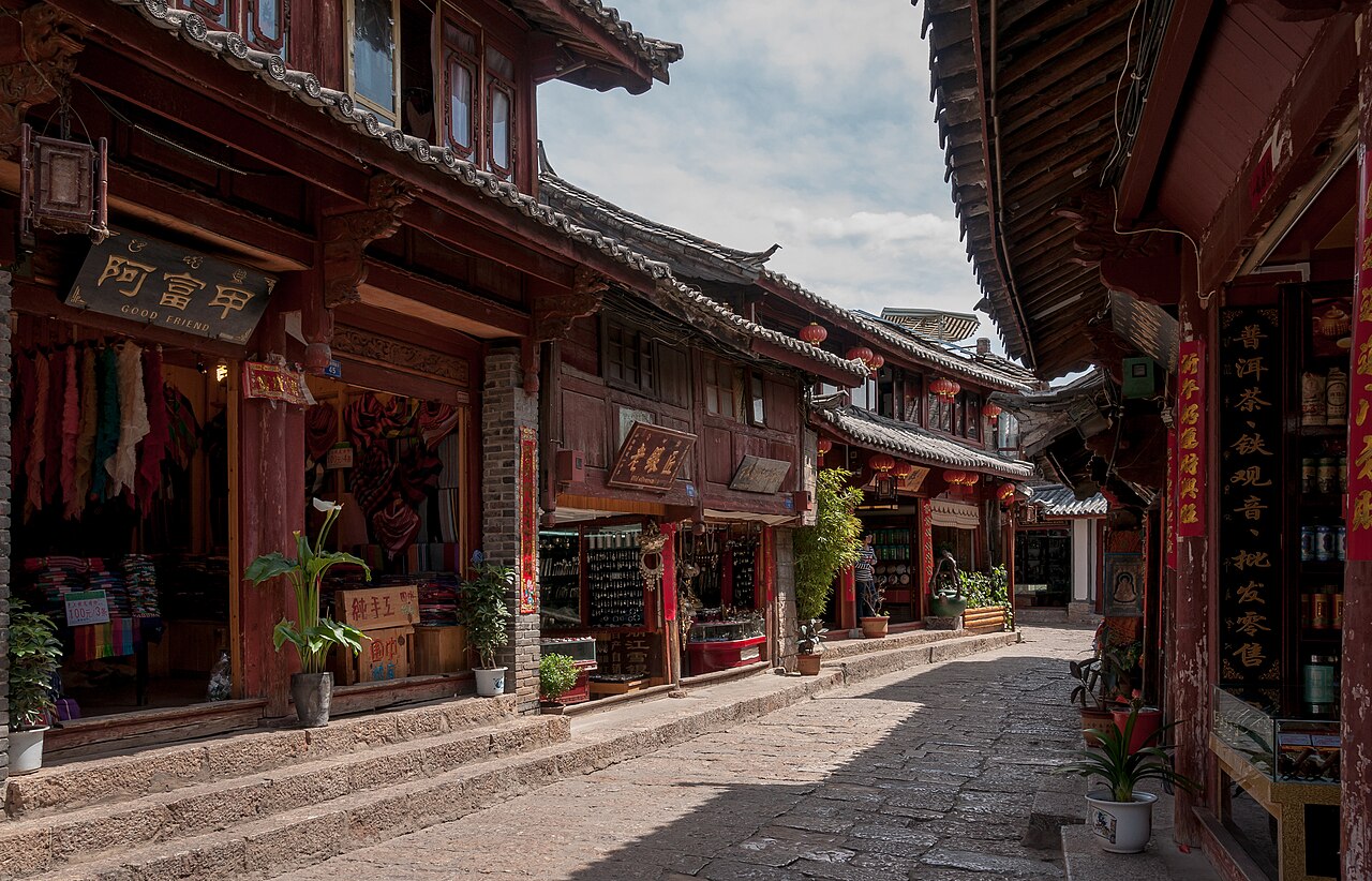 Wooden shops with tiled roofs along a lane in Lijiang Old Town