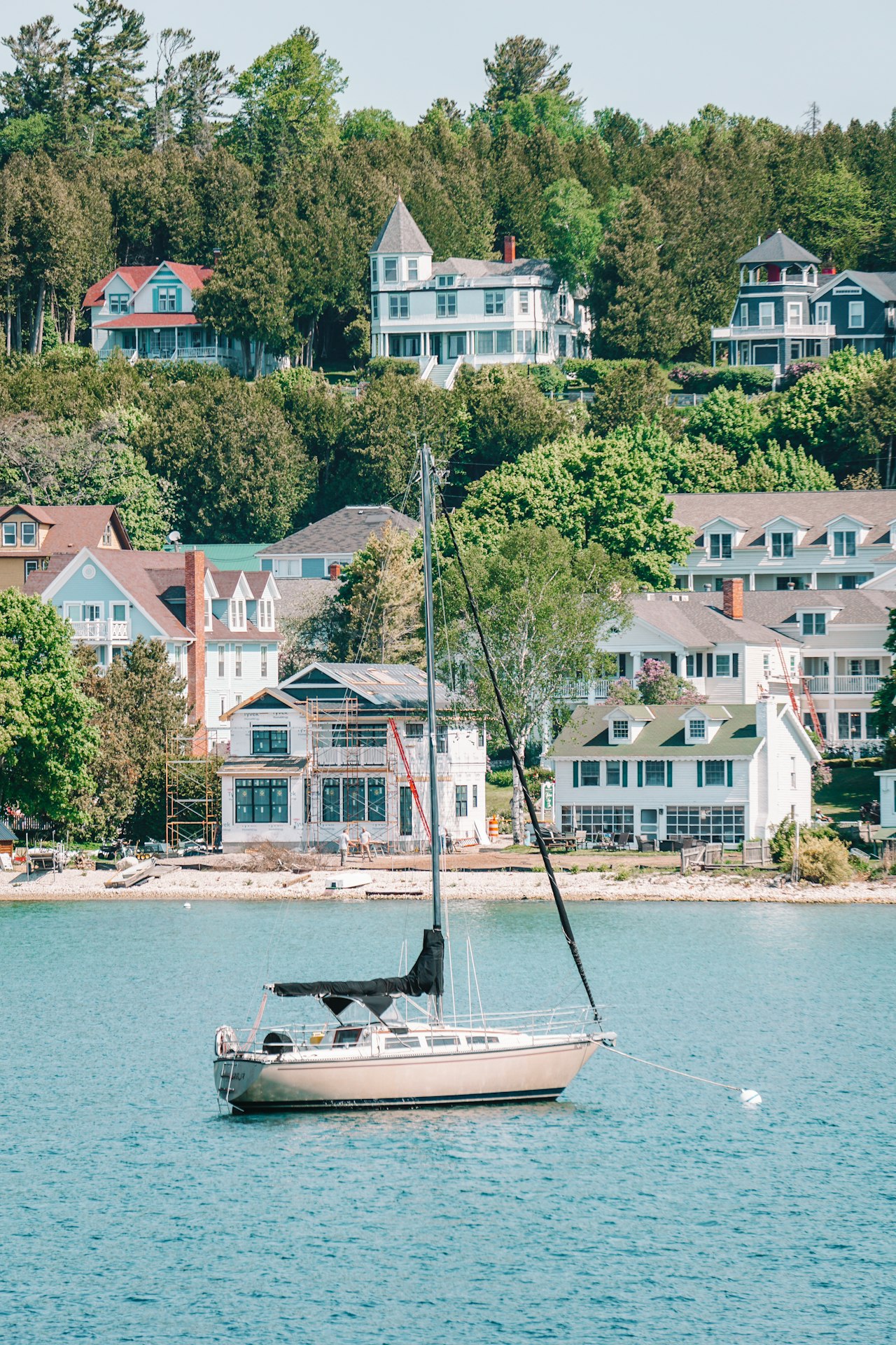 Boat on blue water near a coastal town