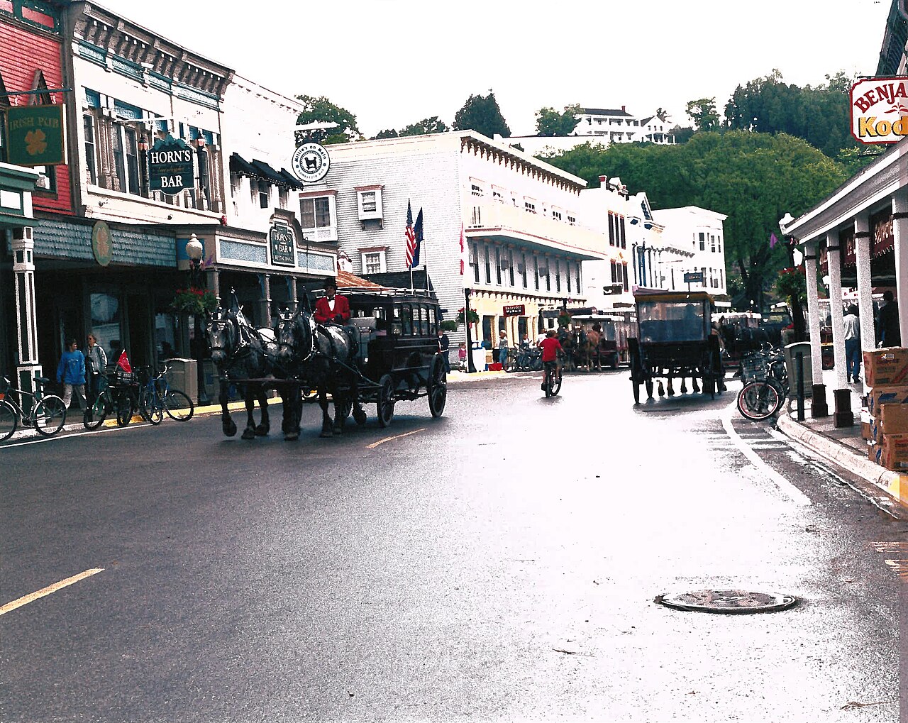 Street with horse carriages and old storefronts