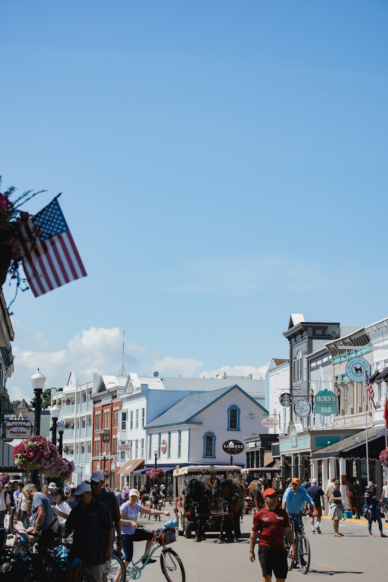 Busy street with shops and an American flag