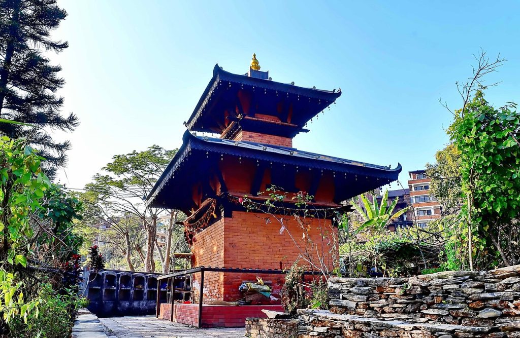 A red brick pagoda temple with tiered blue roofs