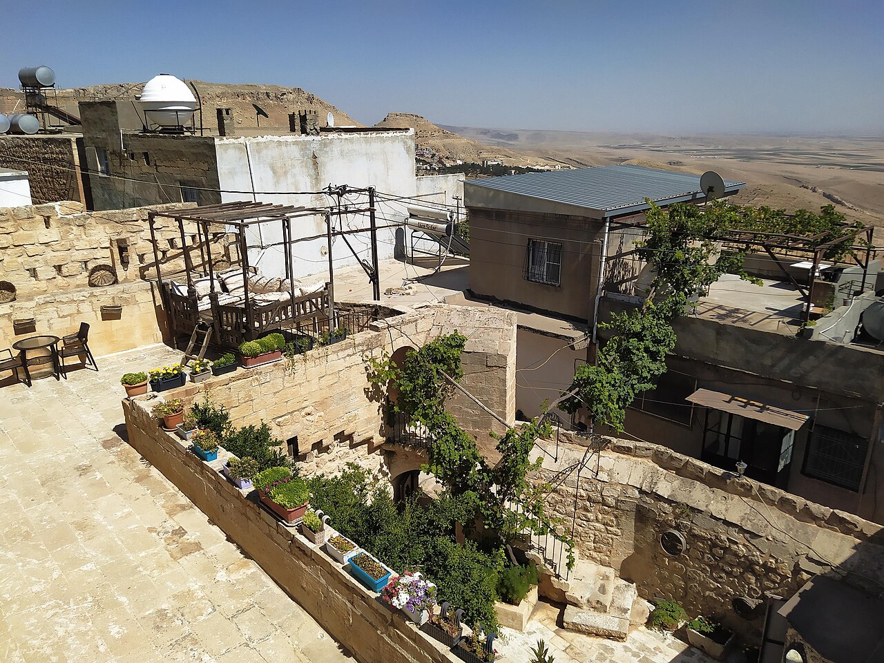 Stone houses of Mardin Turkey stacked on a hillside above the plain