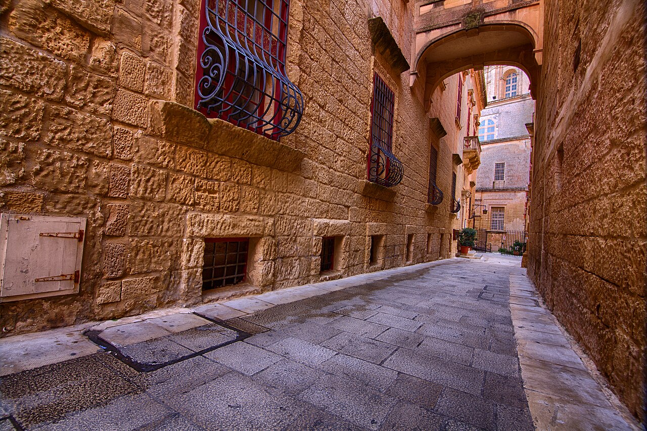 Narrow stone alley with old doors and lanterns