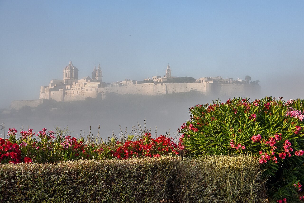 Walls and domes of Mdina Malta rising above morning mist