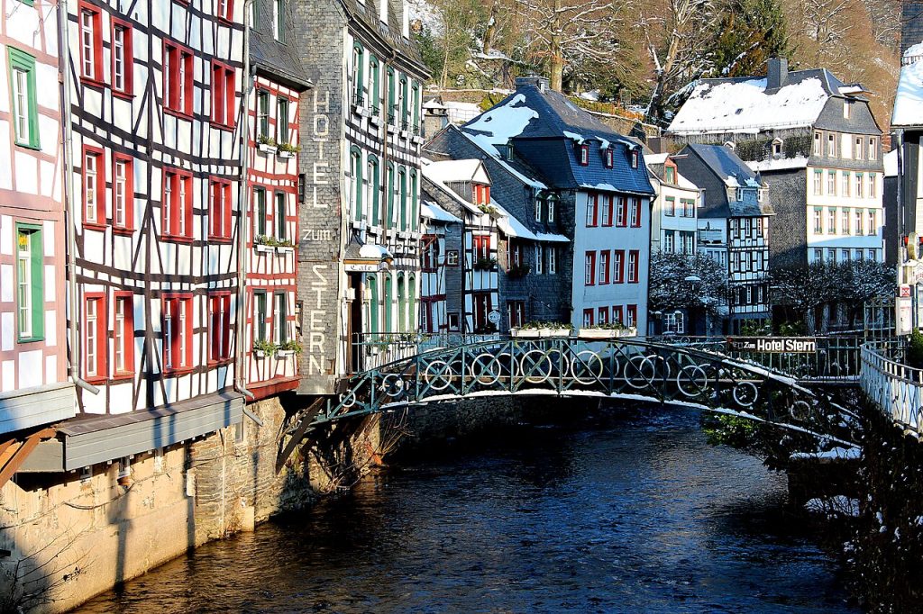 Monschau Germany half-timbered houses beside the Rur River and an iron footbridge