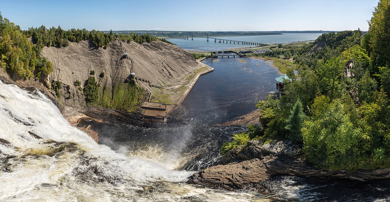 Tall waterfall plunging into a river gorge at Montmorency