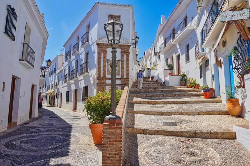 Two white alleys branching off on a sunny day in Frigiliana