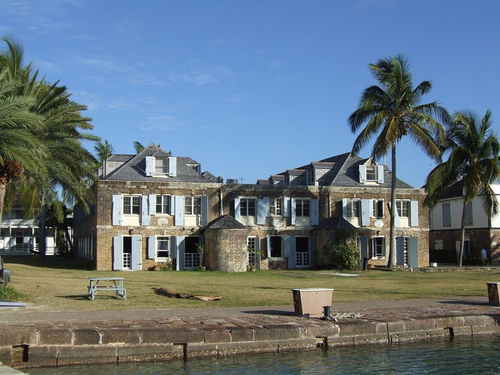 A Georgian stone building with palm trees at Nelson’s Dockyard