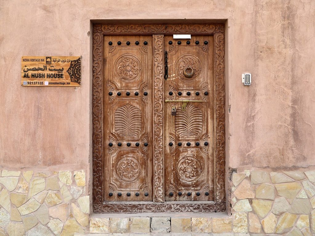 Carved wooden door in the old quarter of Nizwa Oman