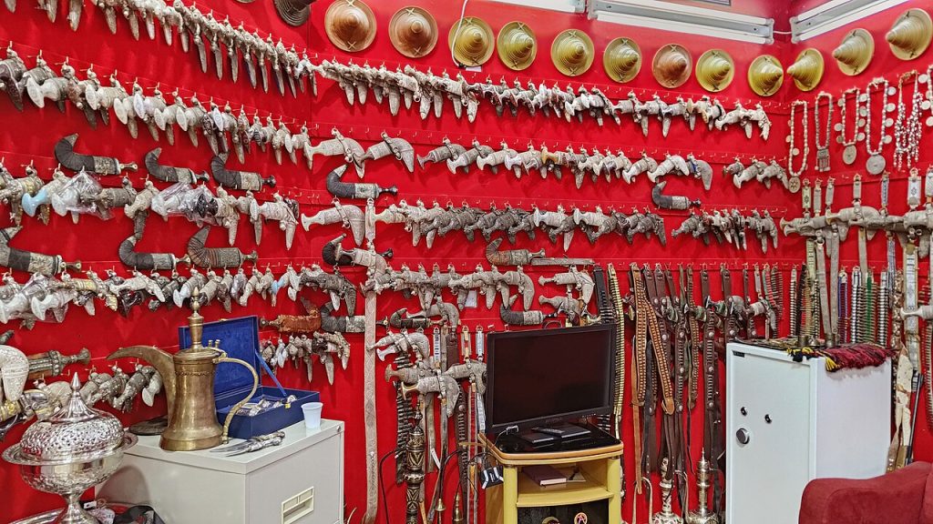 Silver khanjar daggers on display in a souq shop