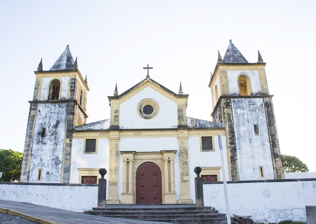 White facade and twin towers of the Sé Cathedral on the hilltop