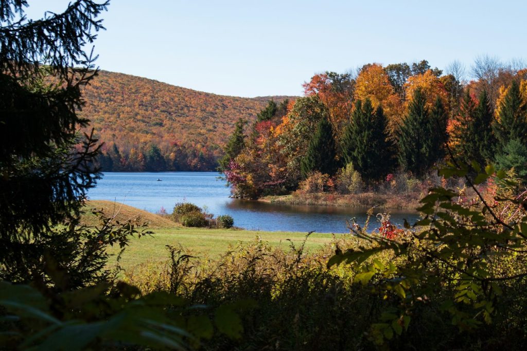 A lake surrounded by autumn forest in the Pocono Mountains