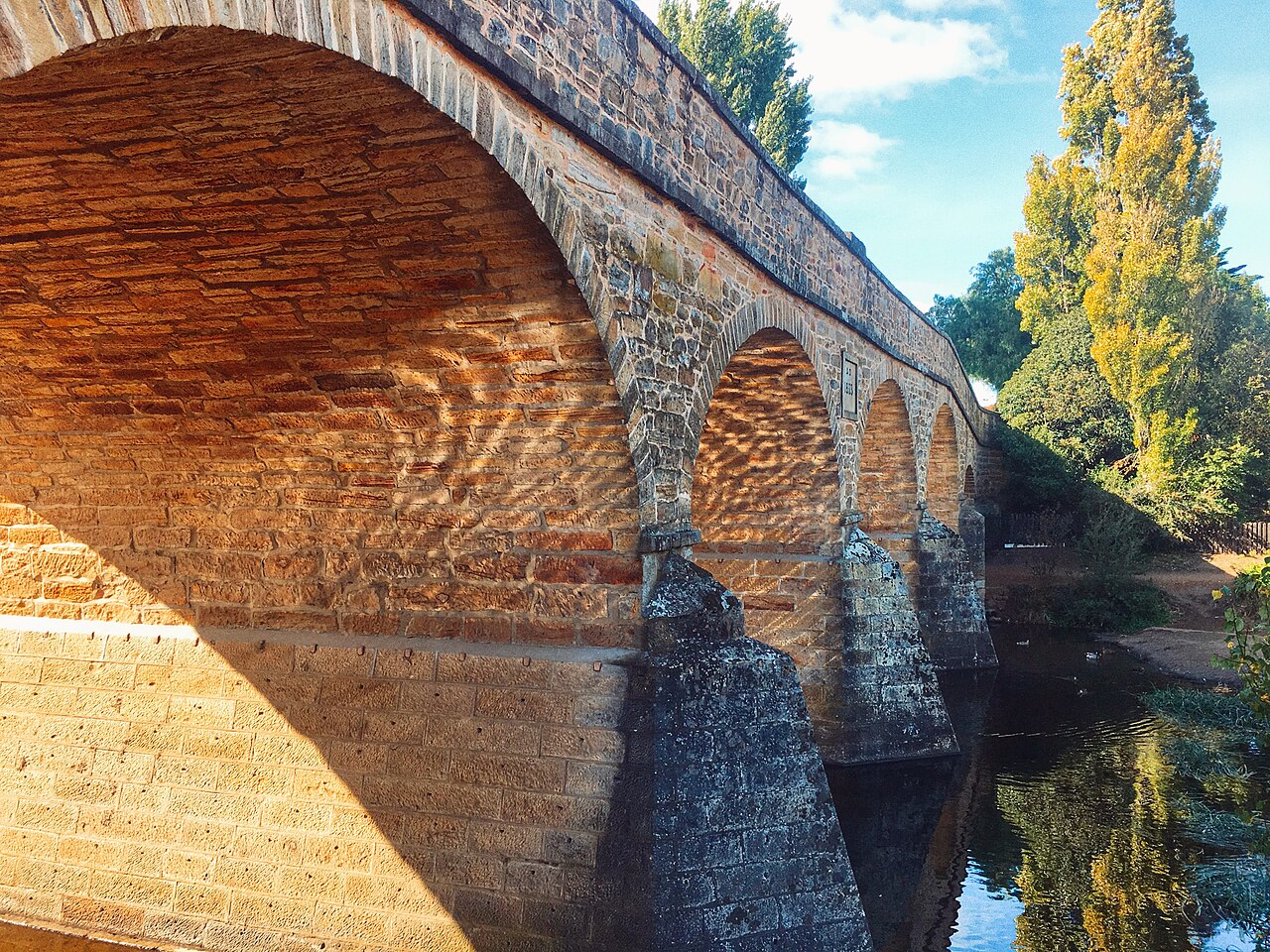 Stone arch bridge with autumn trees