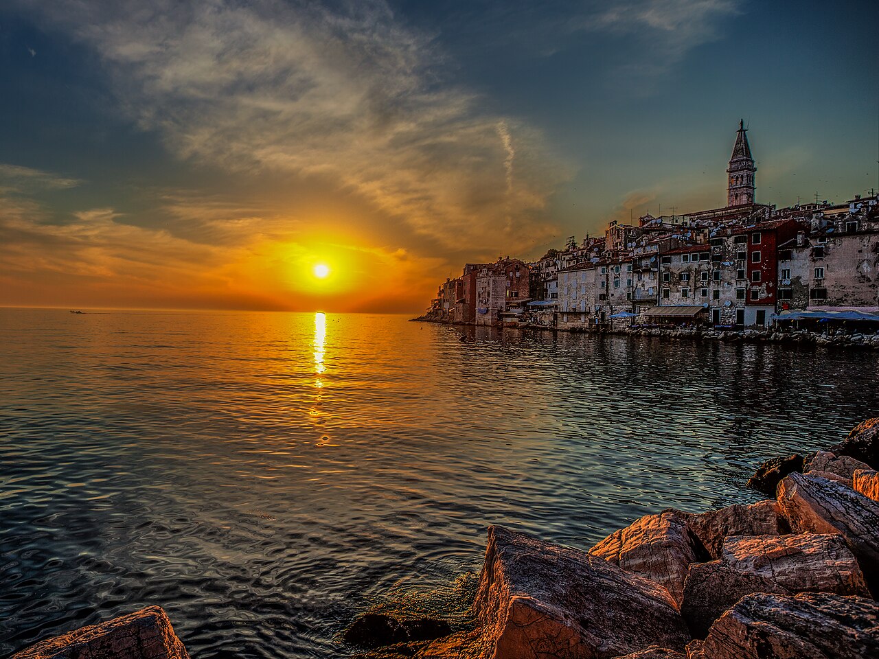 Golden sunset over the sea and old town houses