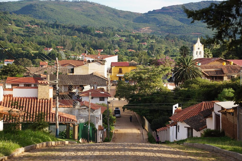 Red tiled rooftops and a church tower in Samaipata