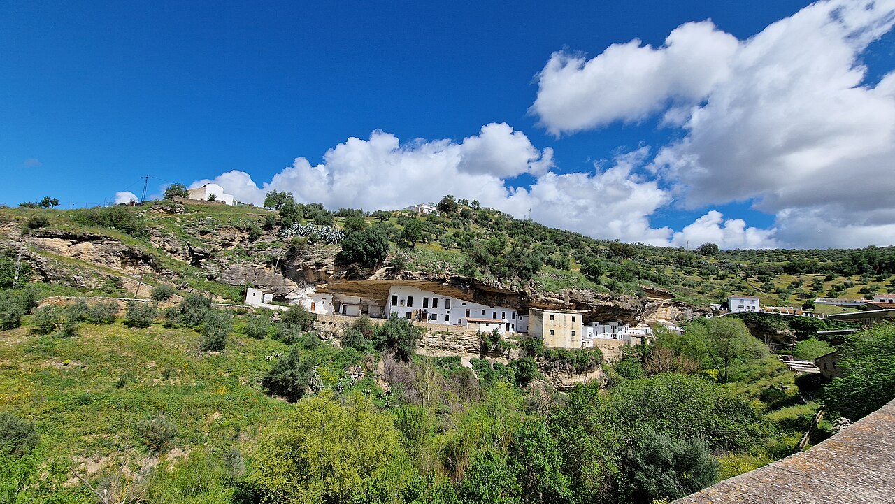 White houses built under a huge rock overhang in Setenil de las Bodegas