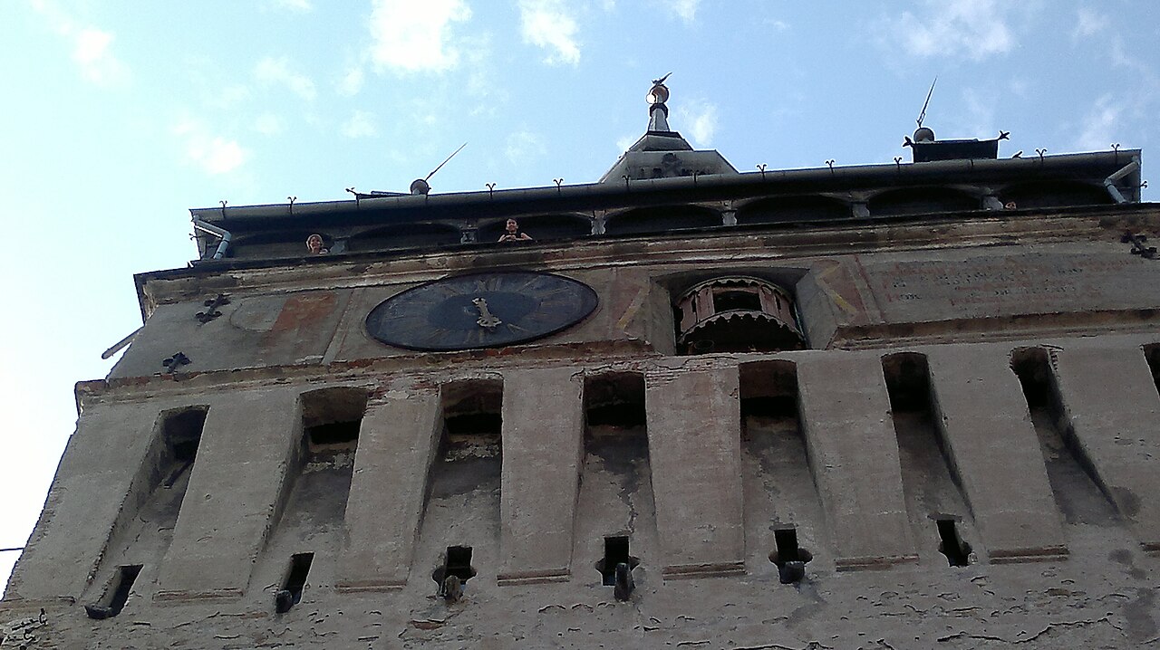 Tall medieval Clock Tower of Sighisoara Romania with a tiled spire
