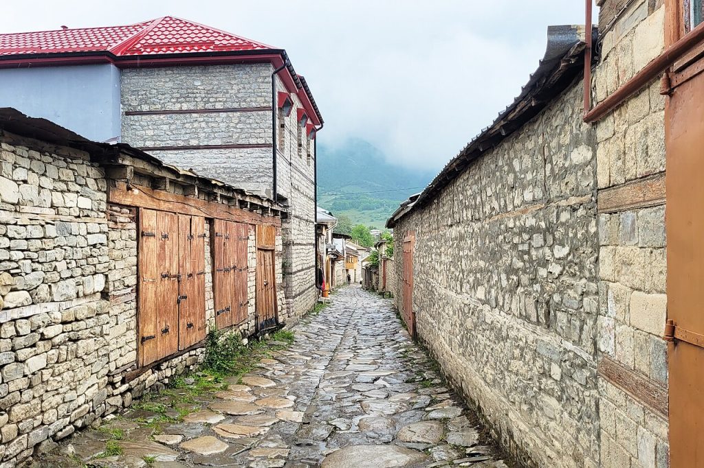 A narrow lane between old stone walls and wooden doors