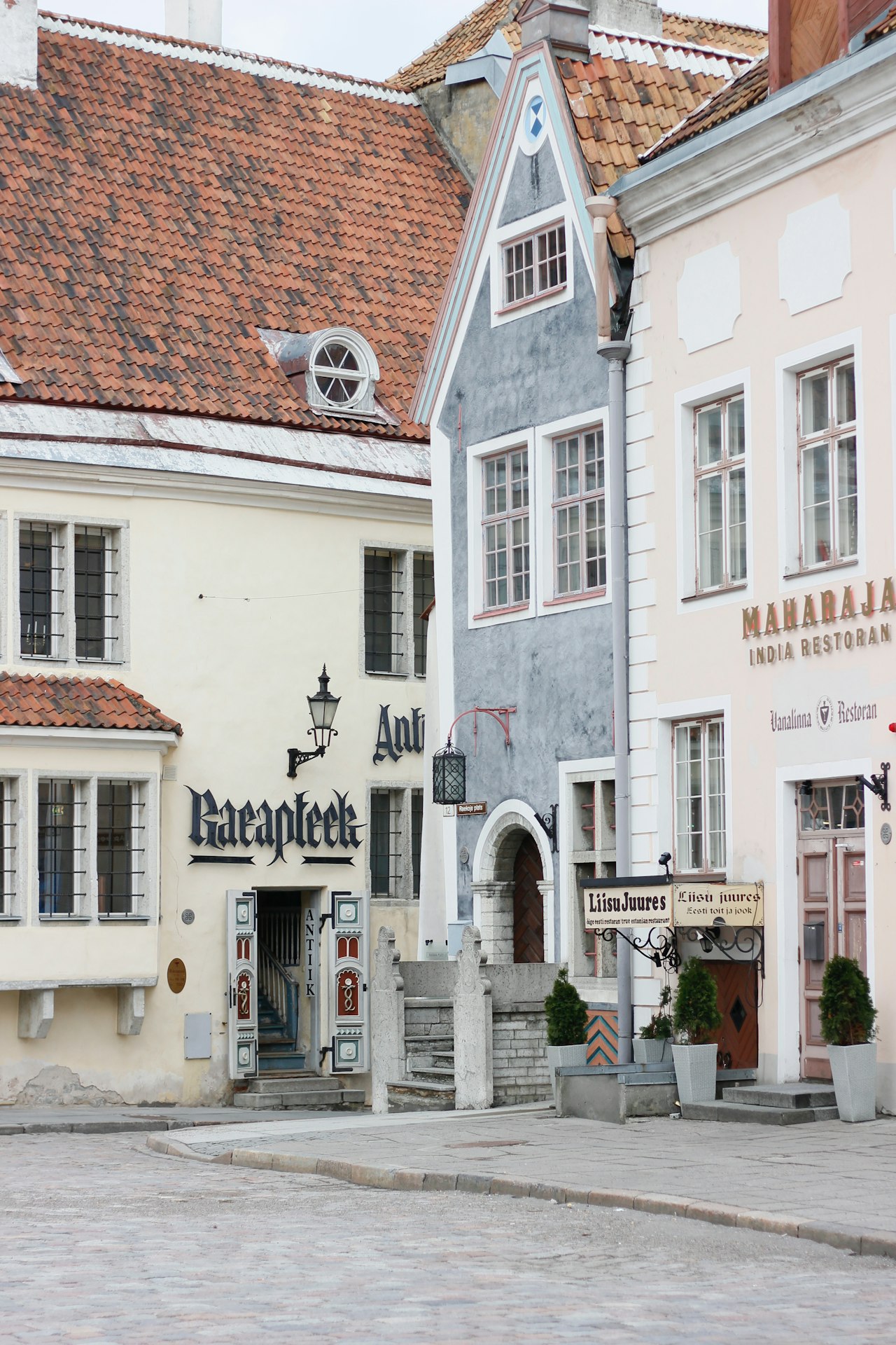 Colourful old houses side by side on a cobbled street