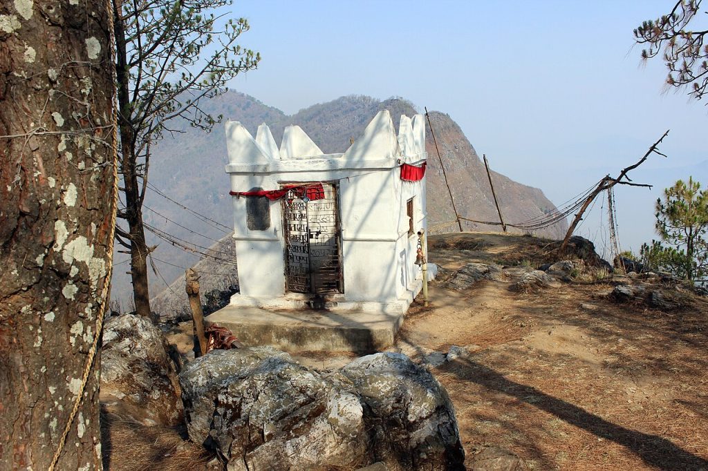 The white Thani Mai shrine on a hilltop